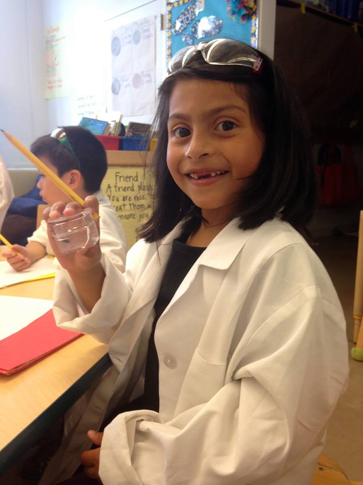 Young girl wearing a lab coat during Horizons program